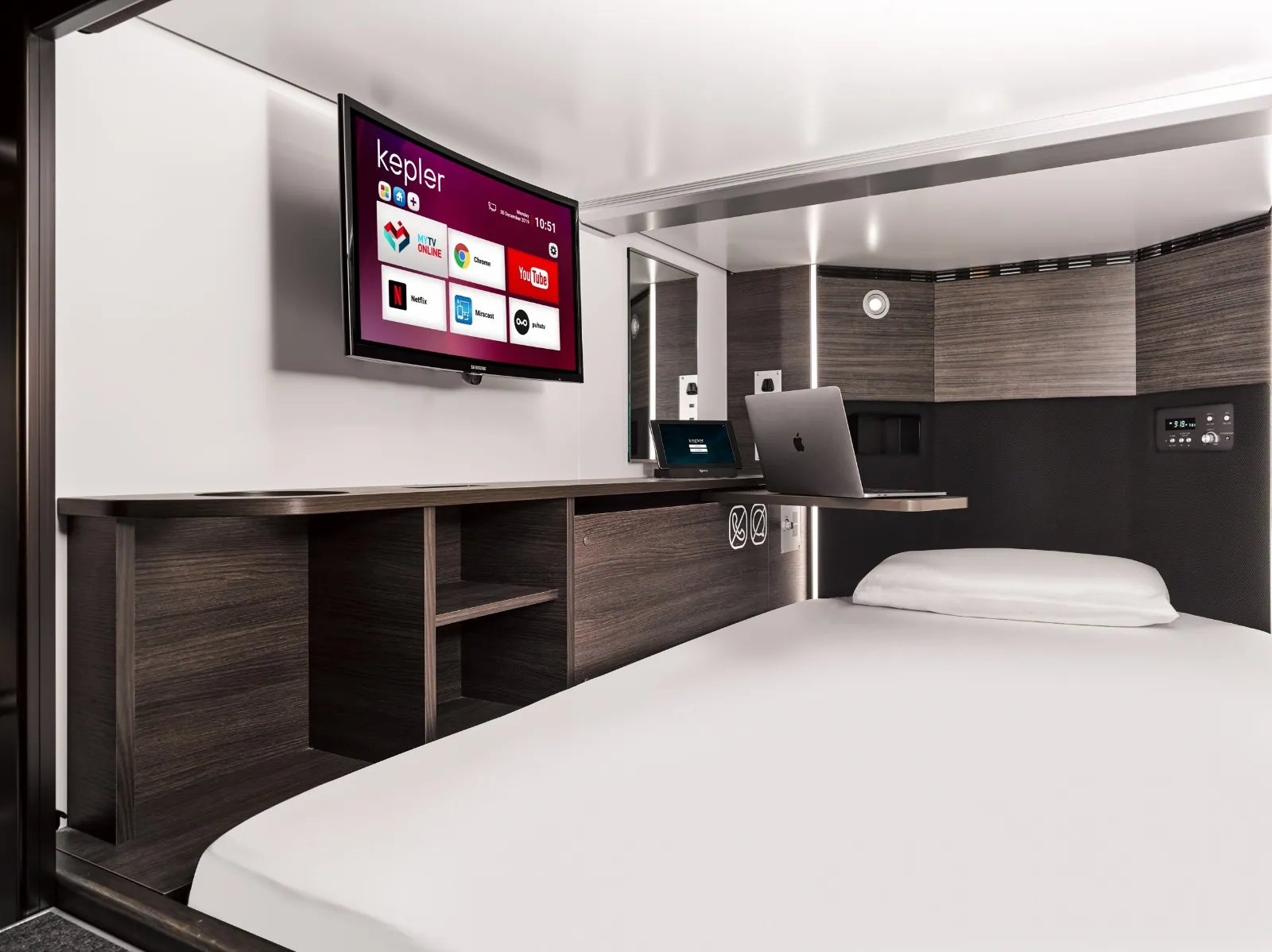 Private airport sleeping pod interior with smart amenities at Kepler transit hotel and sleep lounge