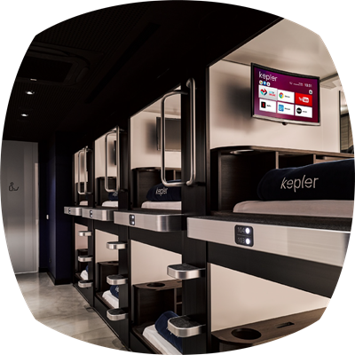 Smart TVs with Netflix and YouTube, universal charging stations, work desks equipped with white noise technology, and ergonomic, comfortable bed units.