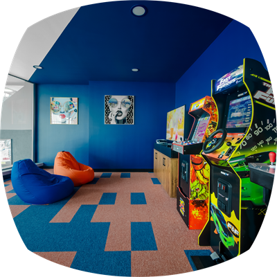 Game area featuring PlayStation and arcade machines for entertainment and fun.